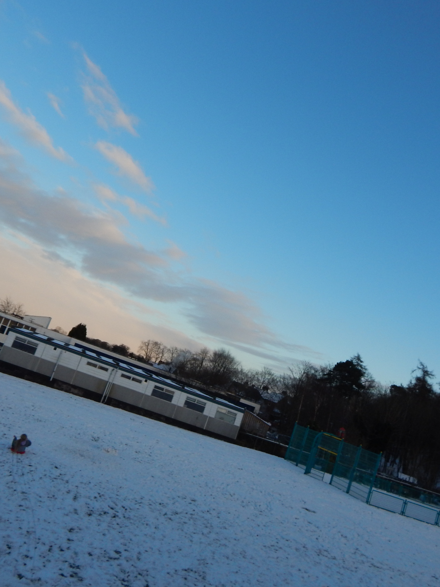 Sophie Coyle: Cambusbarron Primary School with a beautiful sky and my sister sledging down the snowy hill